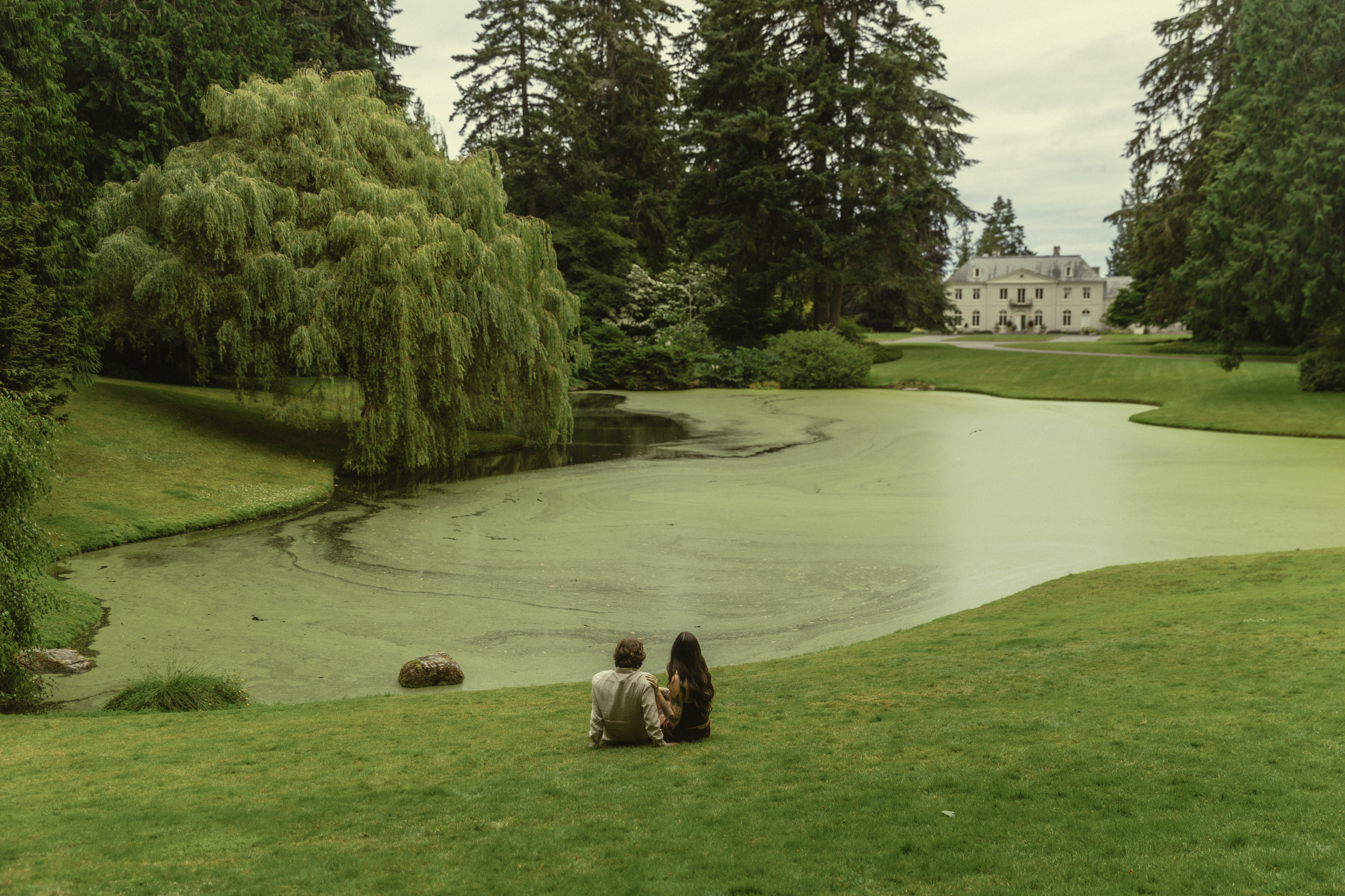 Shelby and Hamza sitting together by the water