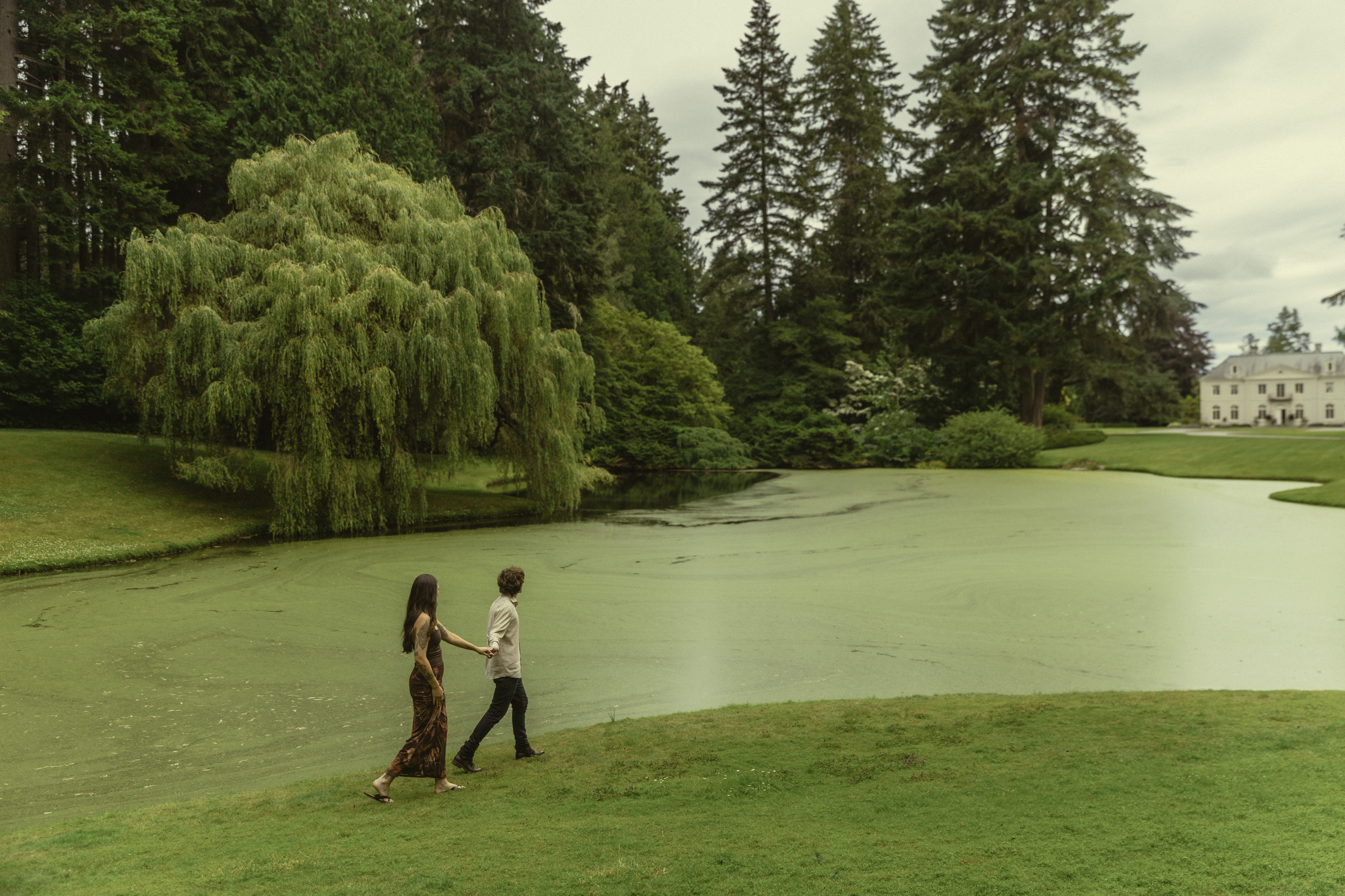 Shelby and Hamza walking beside the pond