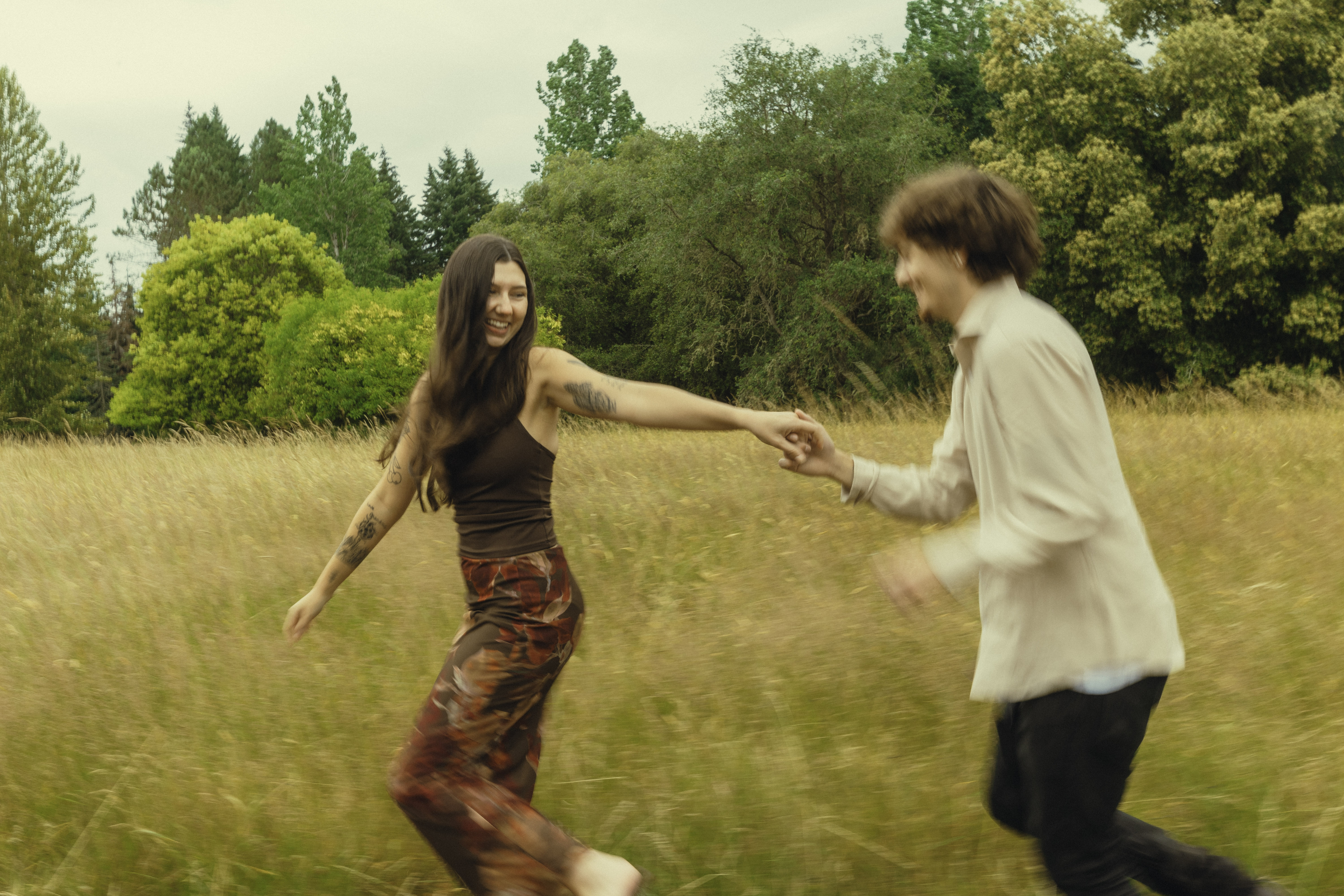Shelby and Hamza running through the grass together